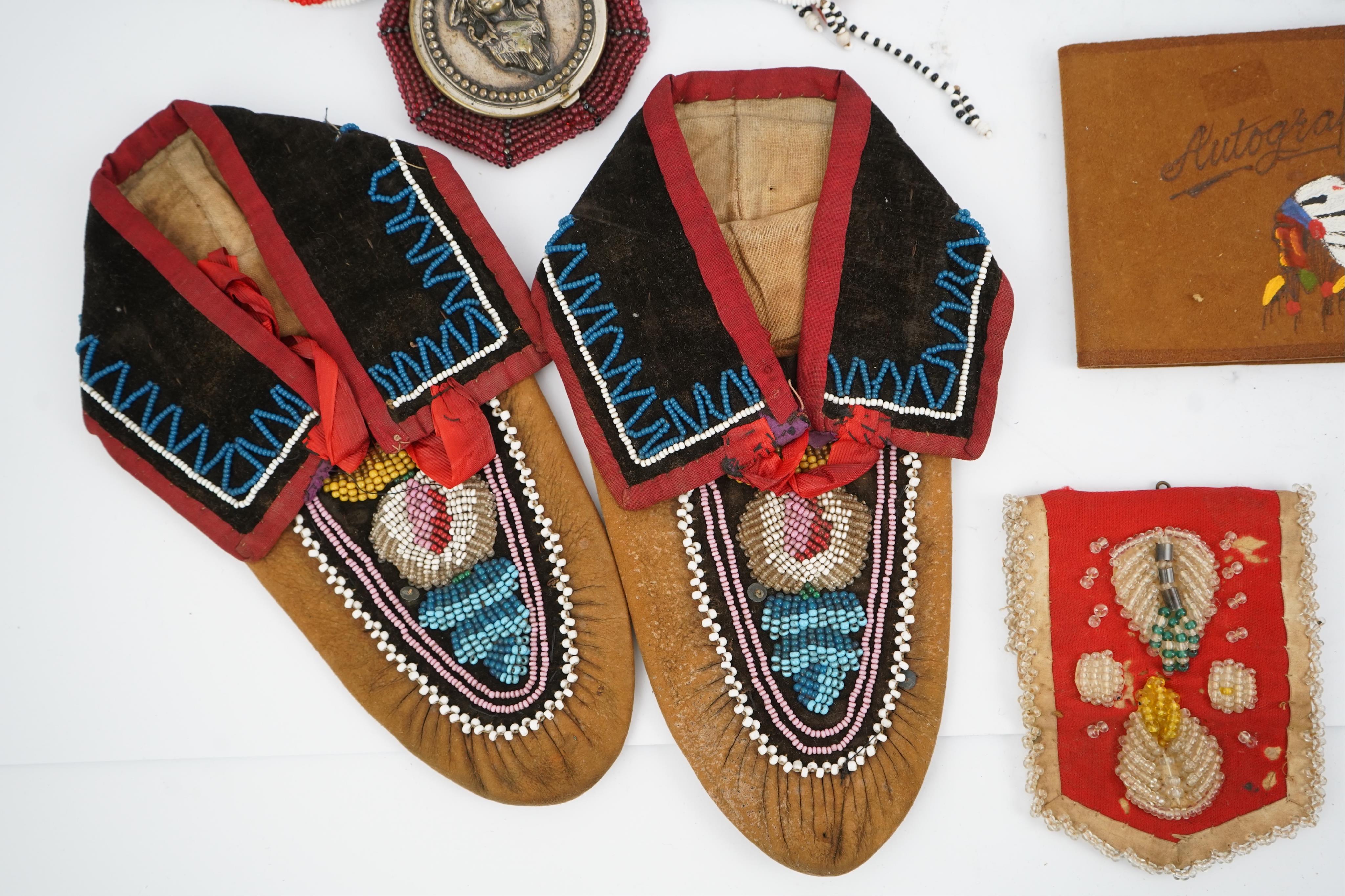 A collection of mixed decorative bead work, including five items of Native American beadwork, together with an early beadwork bag and later beaded items. Condition - moccasins, bead panel, circular bed purse with metal l